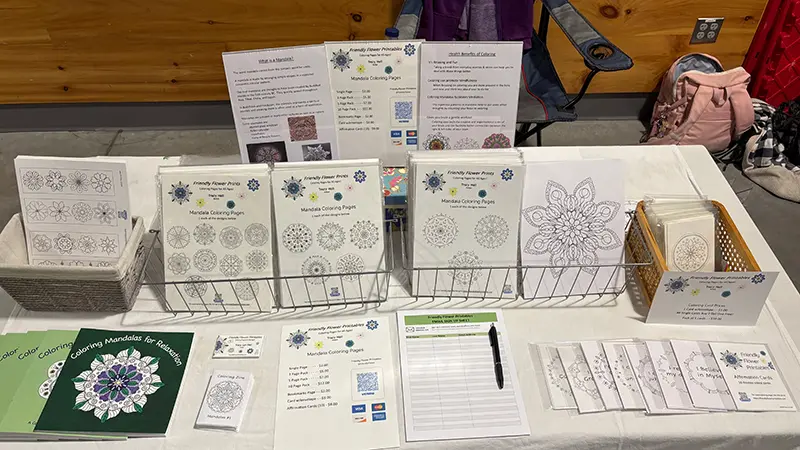 Vendor table setup with coloring pages, books, cards & bookmarks